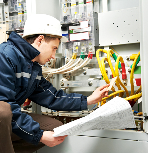 Residential electrician in Orlando, FL reviewing wiring plans and inspecting electrical panel