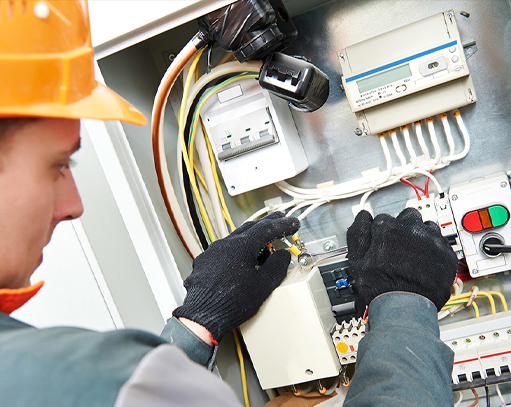 Emergency commercial electrician repairing electrical panel in Orlando, FL business