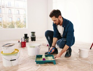 Painter preparing sanding tools before repainting interior walls in Orlando, FL