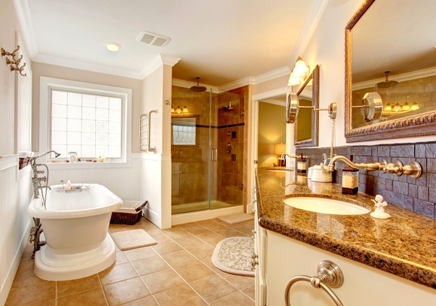 Modern bathroom remodel in Orlando with granite countertops and glass shower by TJ Handyman Services