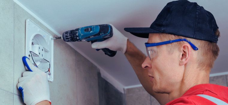 household man fixing exhaust fan 