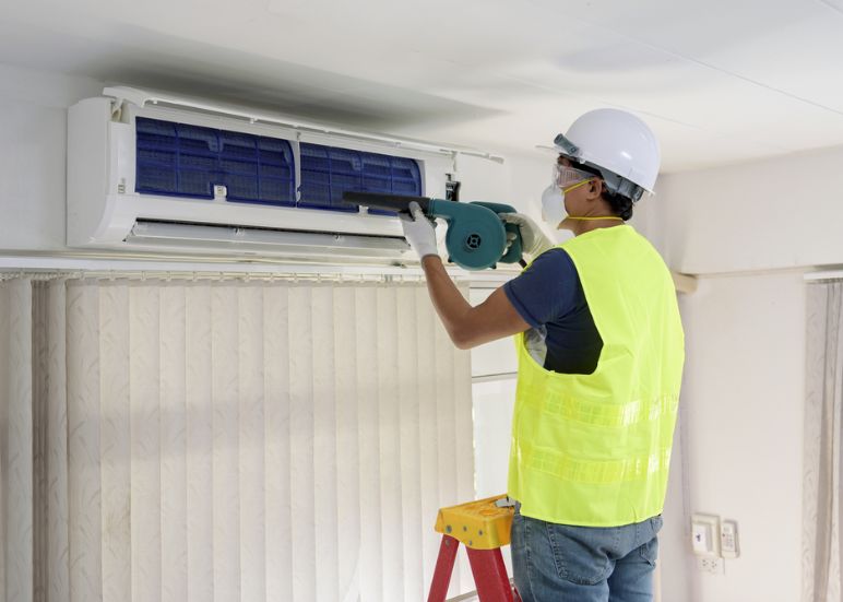 AC technician cleaning Indoor AC