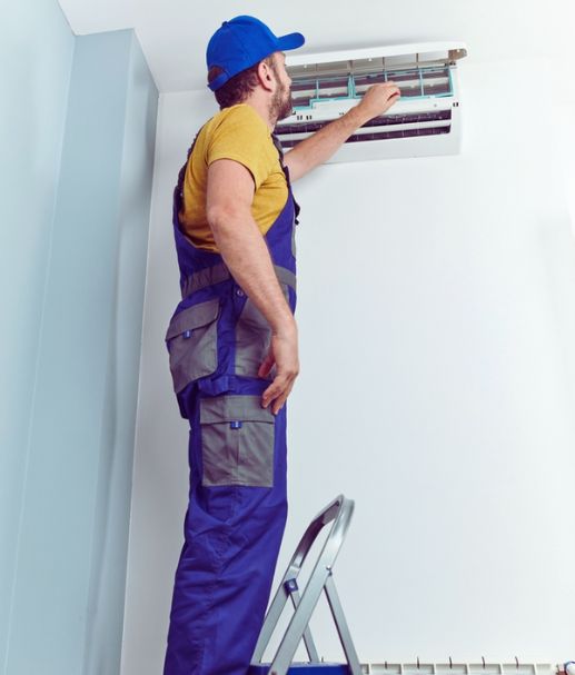 Repairman fixing indoors AC unit