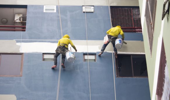 Commercial painters in Winter Park, FL painting the exterior of a multi-story business building